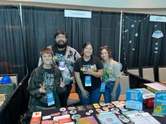 A group of four students tabling for Texas Rising