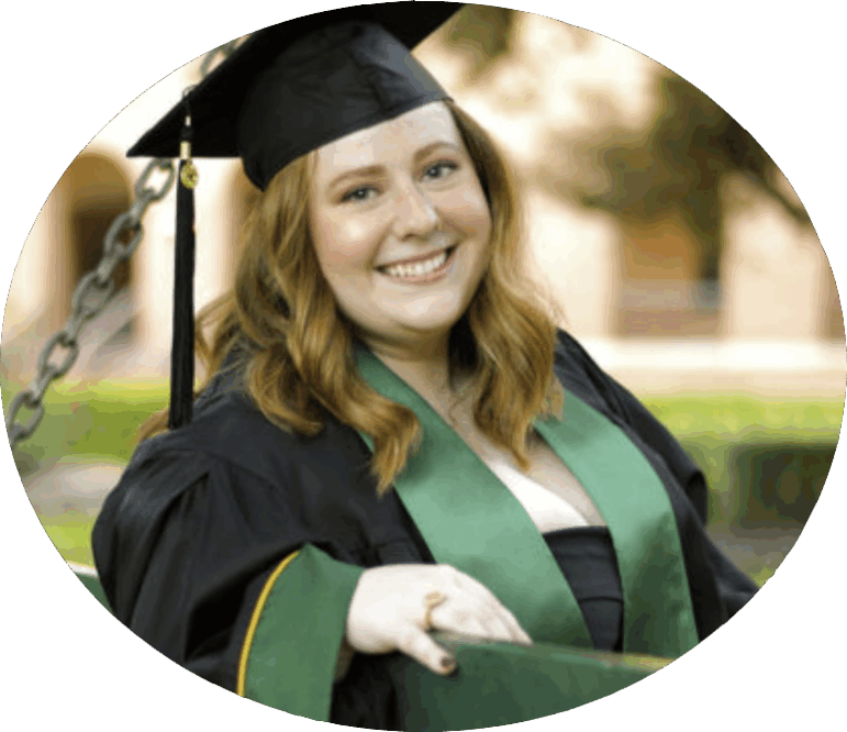 Picture of a smiling graduate with red hair in a cap and gown with a green stole.