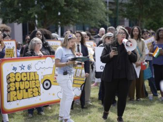 Katt Massey with megaphone at Social Studies Rules rally