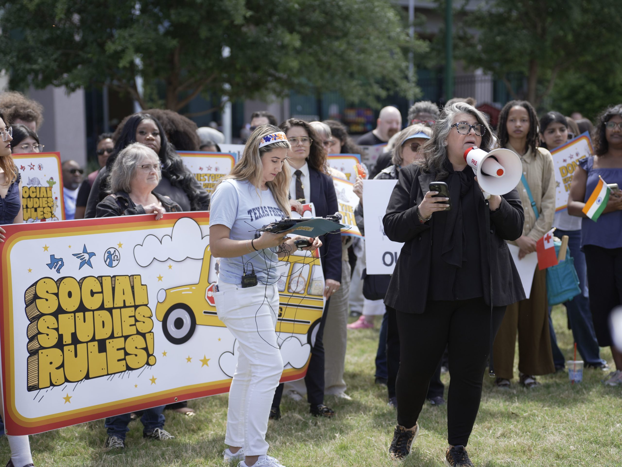 Katt Massey with megaphone at Social Studies Rules rally